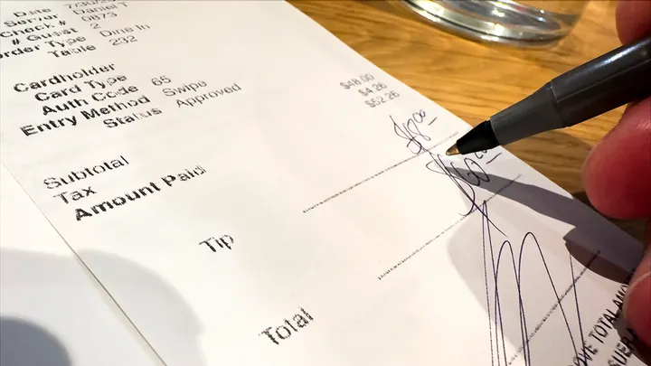 2026 03 28 customer writes tip on restaurant receipt